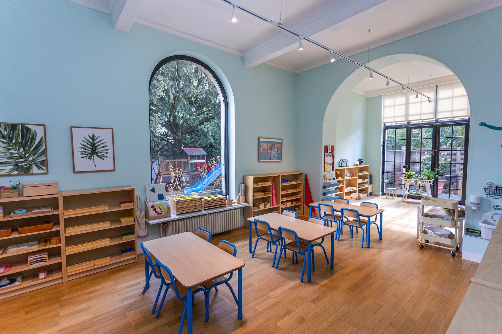 Spacious Montessori classroom with arched ceiling and practical life corner - Stepping Stones Bilingual School Brussels