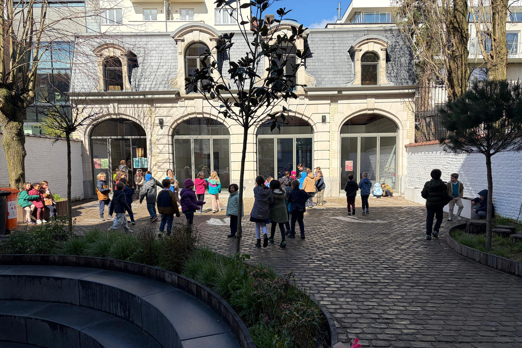 Students at break time in the courtyard of Stepping Stones Primary School, Ixelles Brussels